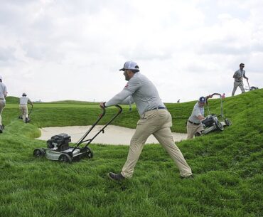 The rough at Oakmont Country Club is trimmed by employees pushing around lawn mowers