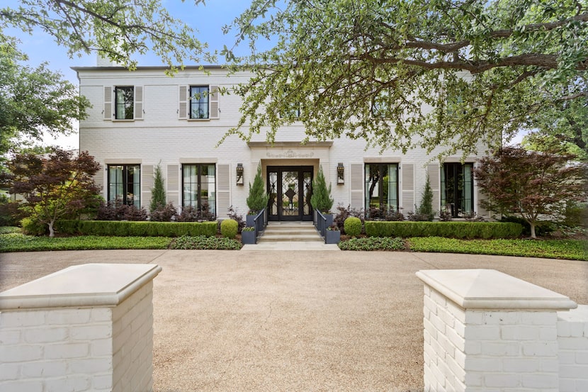 Luxurious white home with mature trees