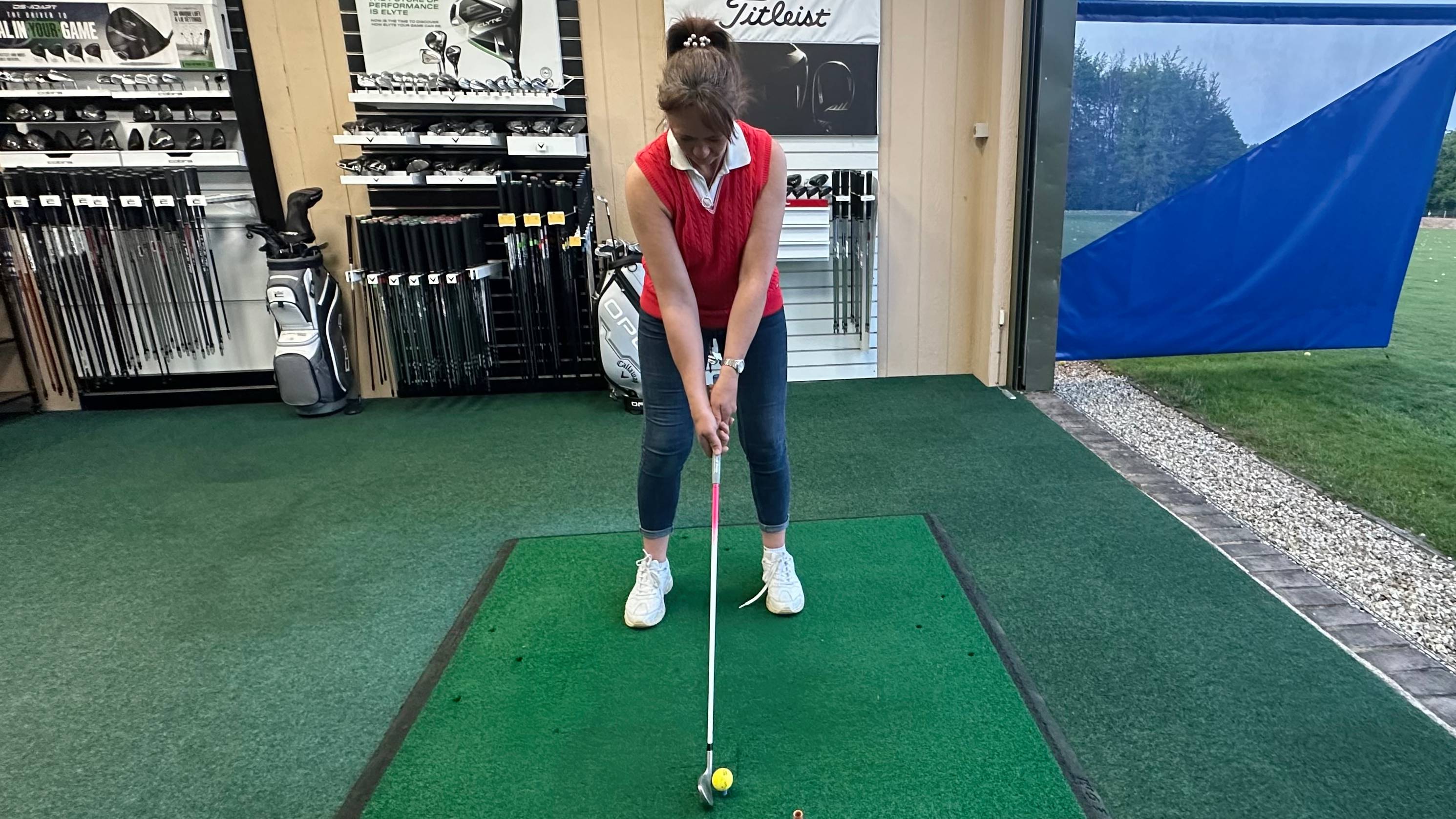 Female golfer hitting a 7-iron with a custom fit grip