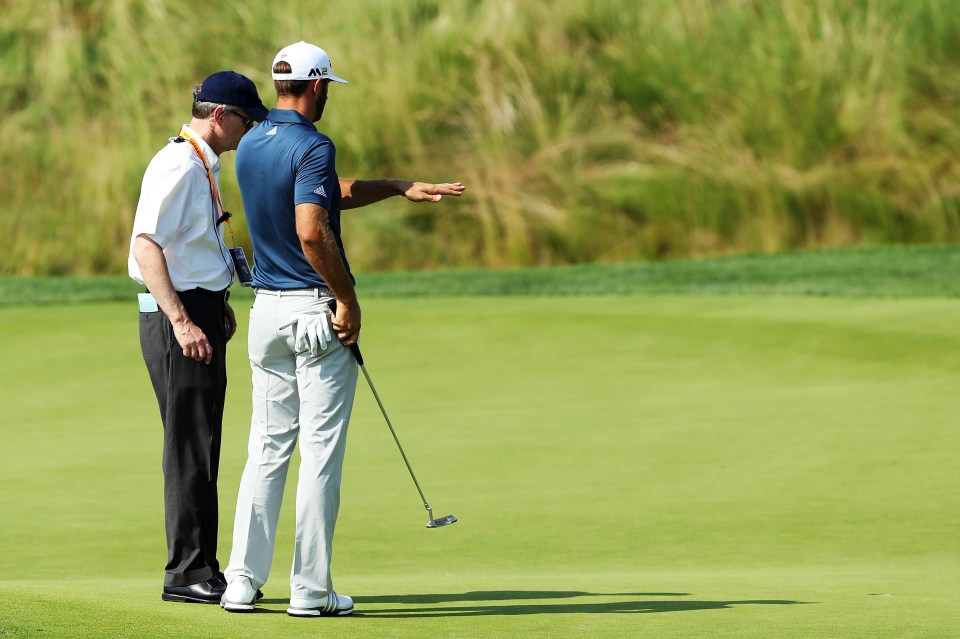 OAKMONT, PA - JUNE 19:  Dustin Johnson of the United States chats with a rules official on the fifth green during the final round of the U.S. Open at Oakmont Country Club on June 19, 2016 in Oakmont, Pennsylvania.  (Photo by David Cannon/Getty Images)