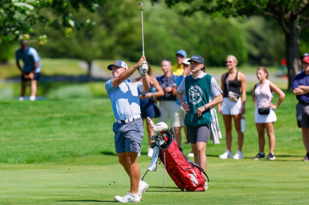 Long Meadow's Trevor Drew follows his approach shot during the second round of the 100th Lowell City Golf Tournament on Friday at Long Meadow Golf Club. He will take a nine-shot lead into the final round Saturday. (James Thomas for the Lowell Sun)