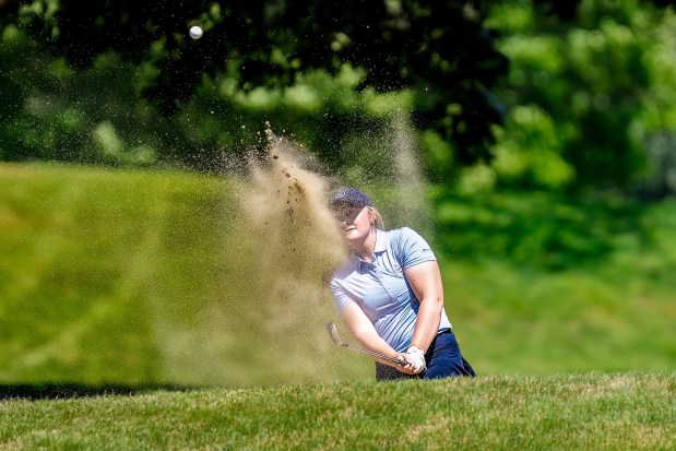 Morgan Smith blasts a shot out of a bunker Friday at Long Meadow. (James Thomas for the Lowell Sun)