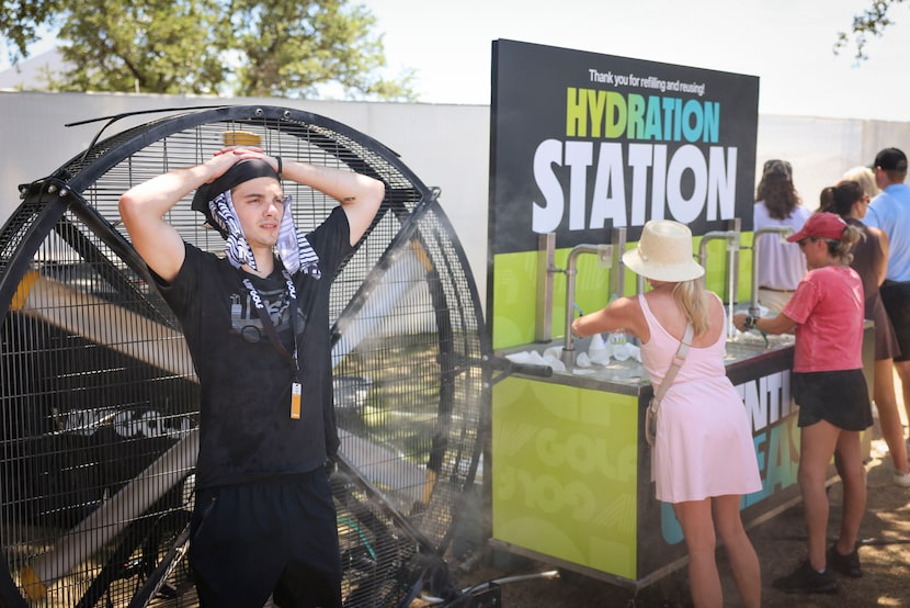 Easton Rodgers cools off by the misting fan during the second day of LIV Golf Dallas, on...