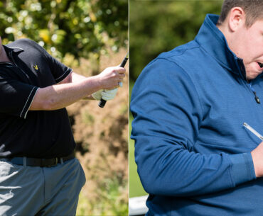 A golfer hits a wedge shot, another golfer marks a card