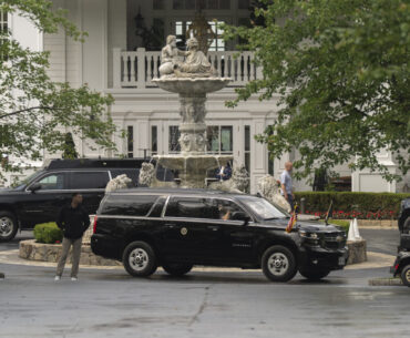 The presidential vehicle carrying President Donald Trump leaves Trump National Golf Club in Sterlin...