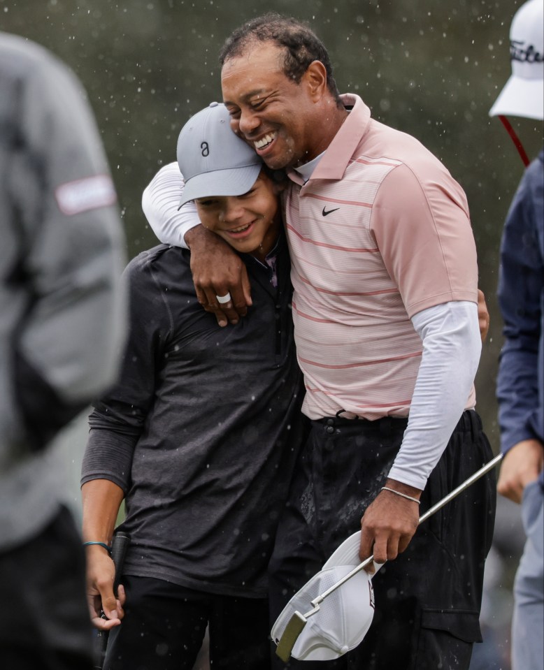 Tiger Woods hugs his son Charlie.