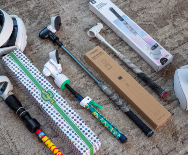 A handful of different Meta Quest golf club accessories alongside a Meta Quest 3 and Quest 3S headset