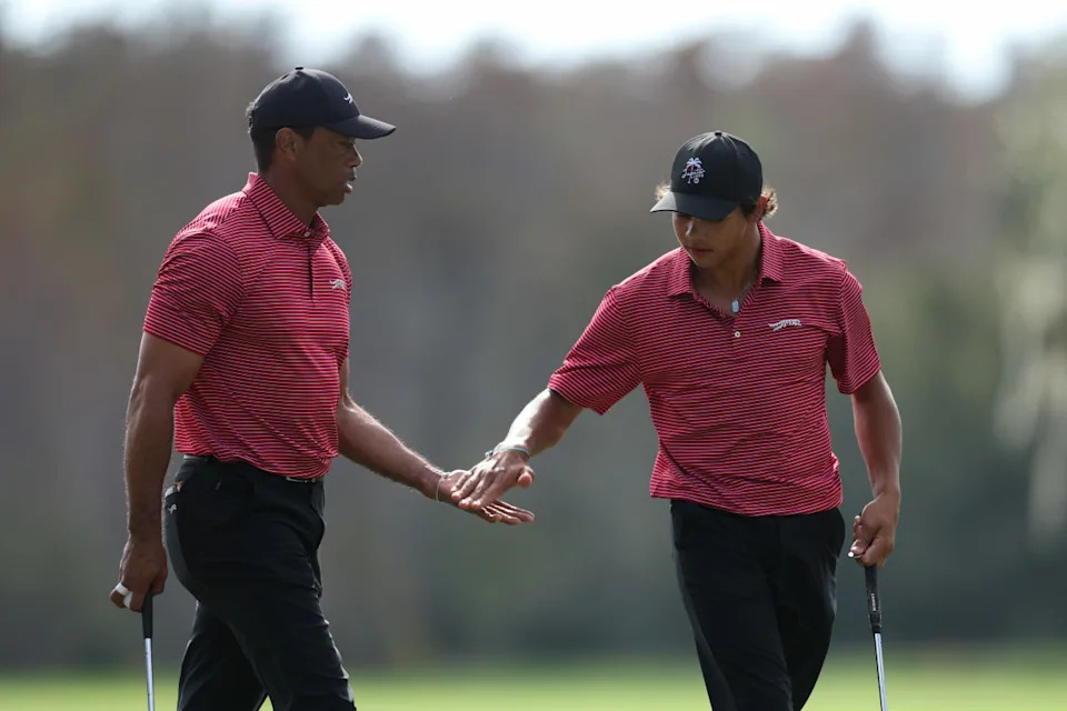 Orlando, Florida, [USA]; Tiger Woods and son Charlie Woods celebrate after a putt on the ninth green during the PNC Championship at The Ritz-Carlton Golf Club.Nathan Ray Seebeck-Imagn Images