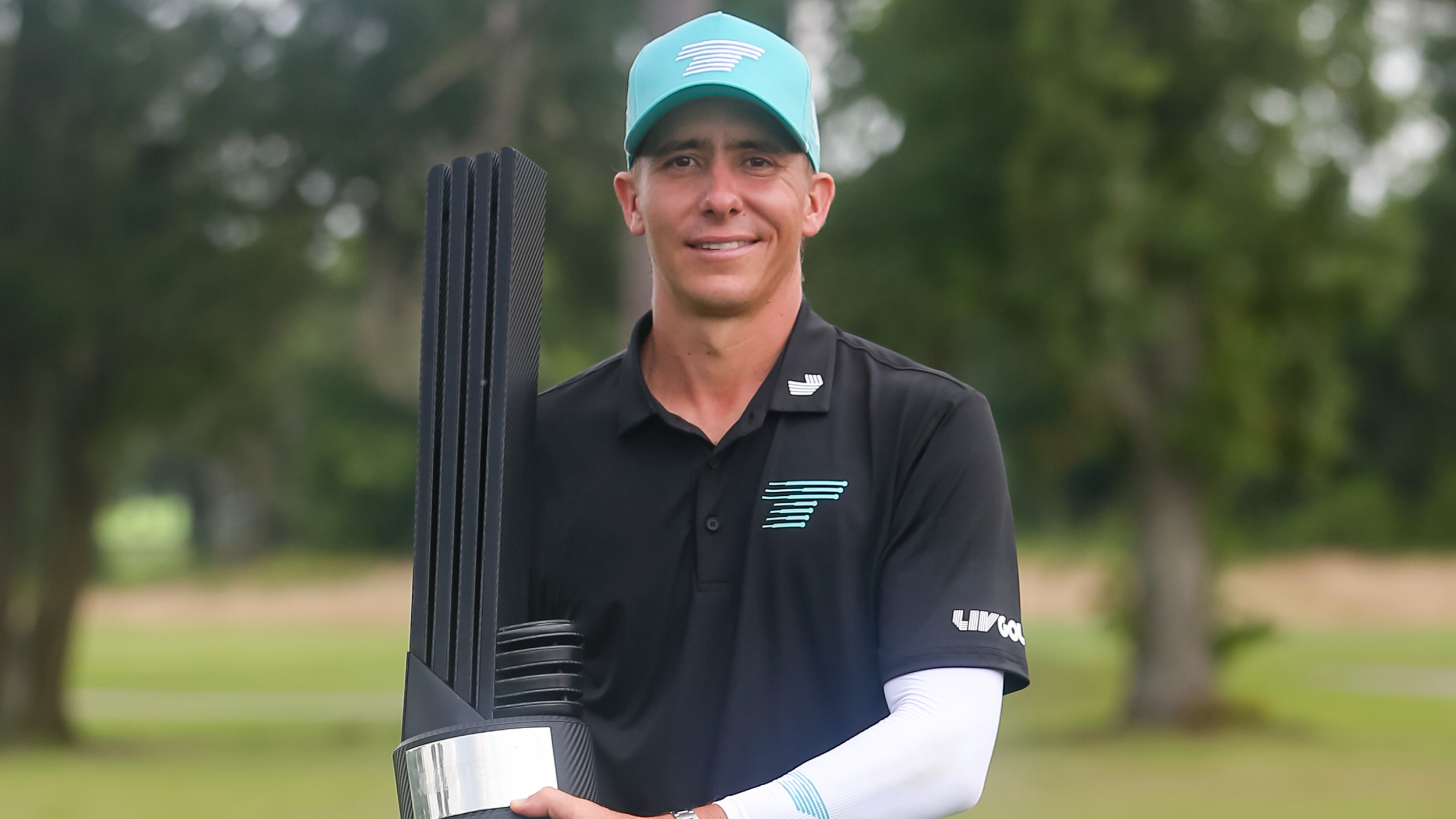 Carlos Ortiz with the LIV Golf Houston trophy