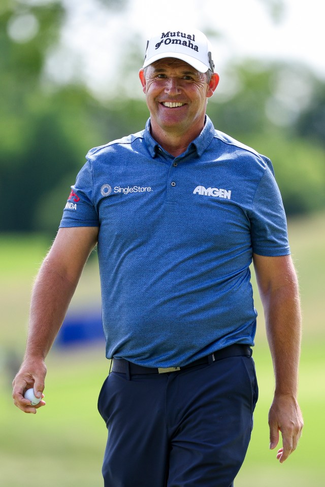 Padraig Harrington smiling on a golf course.
