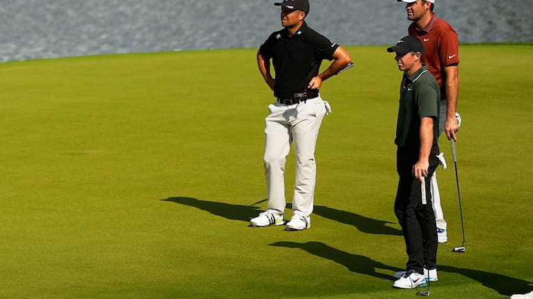 Xander Schauffele, Rory McIlroy, of Northern Ireland, and Scottie Scheffler line up a their putts on the 14th hole during the first round of the PGA Championship golf tournament.q