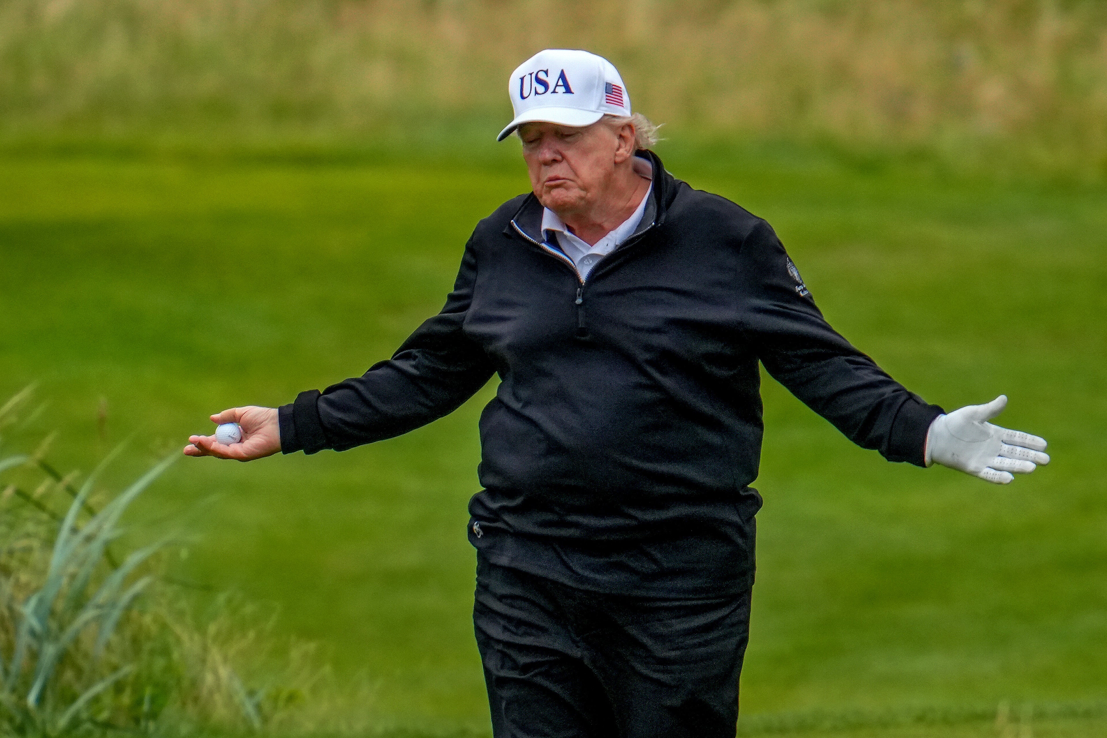 Social media users claim a clip shows Trump’s caddy move his ball during a round of golf in Scotland, the latest in a long string of allegations that the president cheats at golf