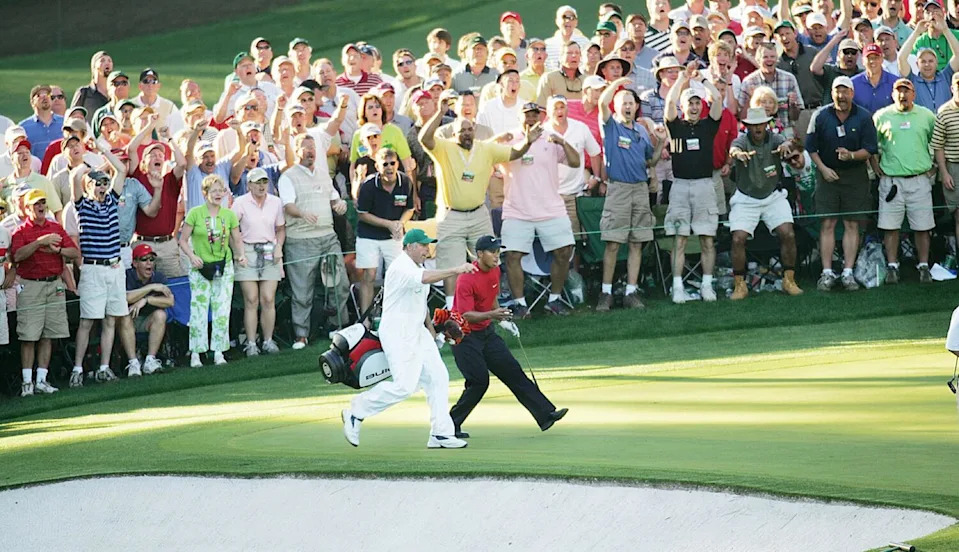 Tiger Woods and caddie Steve Williams watch Woods' chip shot teeter at the edge of the cup at No. 16 during the 2005 Masters.