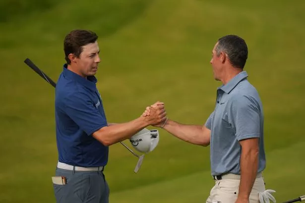 Rory McIlroy shakes hands with Matt Fitzpatrick of England on the 18th green after they completed their final rounds of the British Open golf championship at the Royal Portrush Golf Club, Northern Ireland