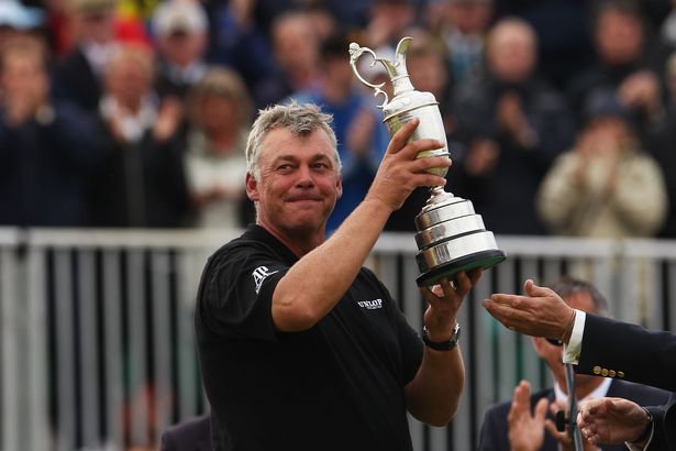 Darren Clarke of Northern Ireland lifts the Claret Jug