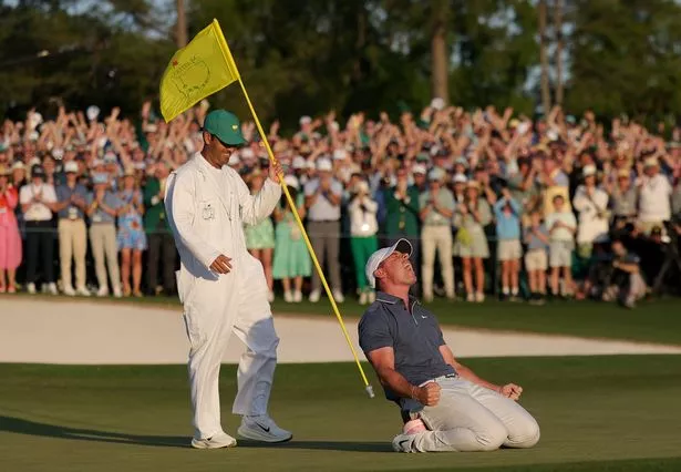 Rory McIlroy of Northern Ireland celebrates winning with caddie Harry Diamond after the playoff hole during the final round of the 2025 Masters Tournament at Augusta National Golf Club on April 13, 2025 in Augusta, Georgia