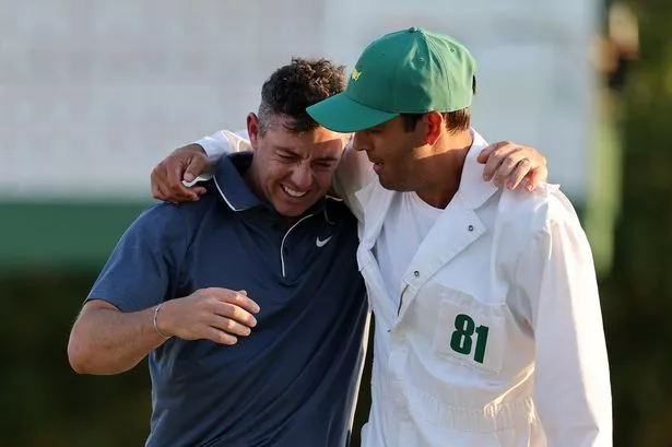 Rory McIlroy of Northern Ireland celebrates winning with caddie Harry Diamond after the playoff hole during the final round of the 2025 Masters Tournament at Augusta National Golf Club on April 13, 2025 in Augusta, Georgia