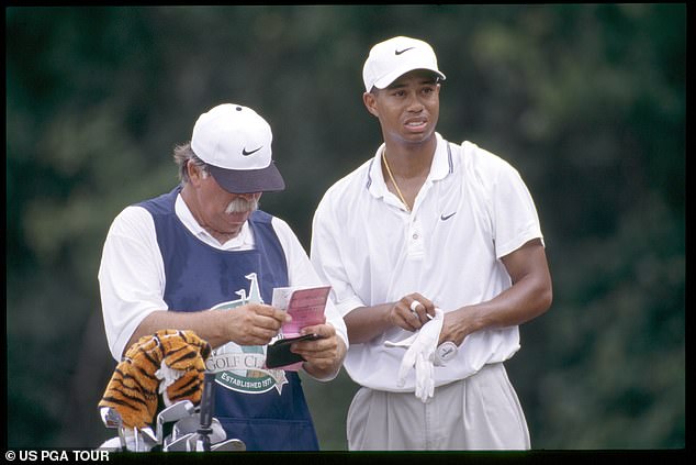 Woods, pictured in 1996 with his caddie Mike 'Fluff' Cowan, was already a golfing superstar