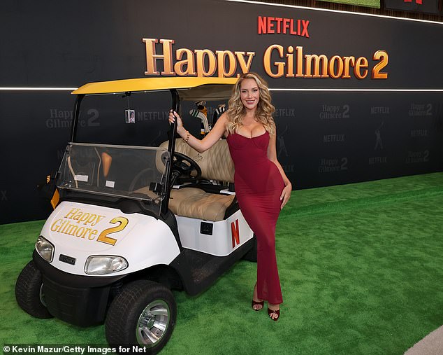 Spiranac poses alongside a golf cart as she celebrated her Hollywood debut in New York