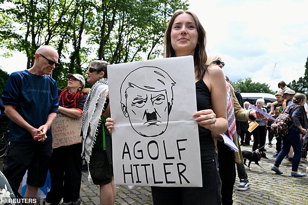 Some protesters hit out at the golf-loving president's appearance over the weekend, with one seen holding a sign branding him 'Agolf Hitler'