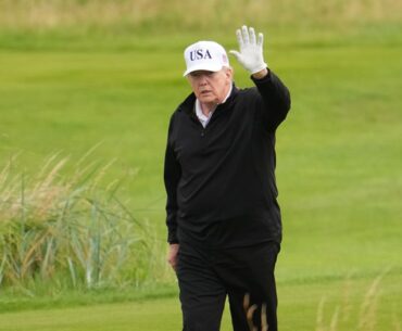 President Donald Trump waves to the media as he plays golf at Turnberry during his visit in July 2025.