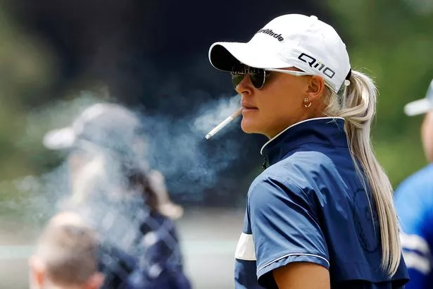 Charley Hull of England smokes a cigarette on the 9th tee during the first round of the U.S. Women's Open Presented by Ally at Lancaster Country Club