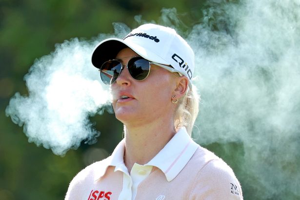 LPGA golfer Charley Hull smokes a cigarette while she walks the 8th hole during the final round of the Kroger Queen City Championship