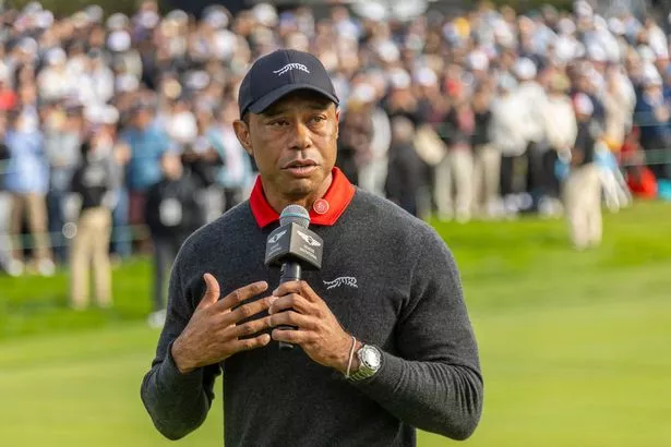 Tiger Woods talking into a microphone 