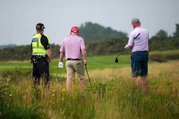 A Police Scotland officer guards a tee and a green at the Trump Turnberry course