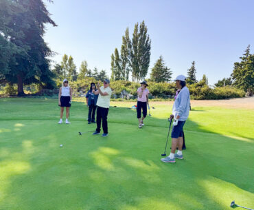 Jane Guiltinan, instructor, teaches students how to line up a putt.