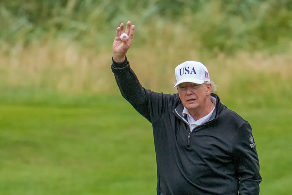 President Donald Trump holds up a golf ball as he plays a round of golf at Trump Turnberry golf course during his visit to the UK