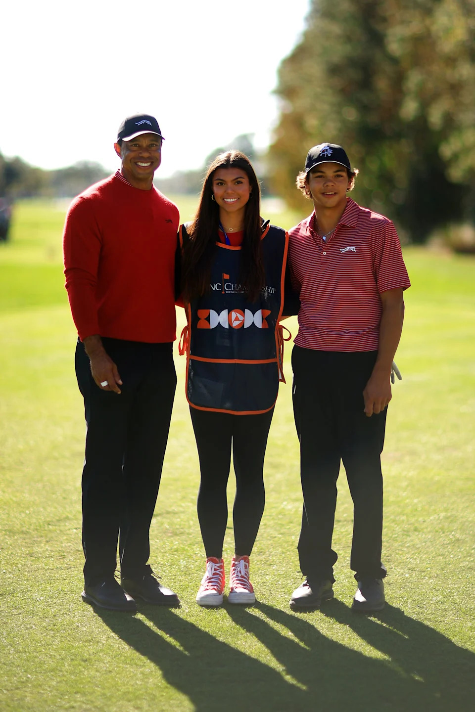 ORLANDO, FLORIDA - DECEMBER 22: Tiger Woods of the United States with his son Charlie Woods and daughter Sam Woods stand on the first tee during the second round of the PNC Championship at Ritz-Carlton Golf Club on December 22, 2024 in Orlando, Florida. (Photo by Mike Ehrmann/Getty Images)