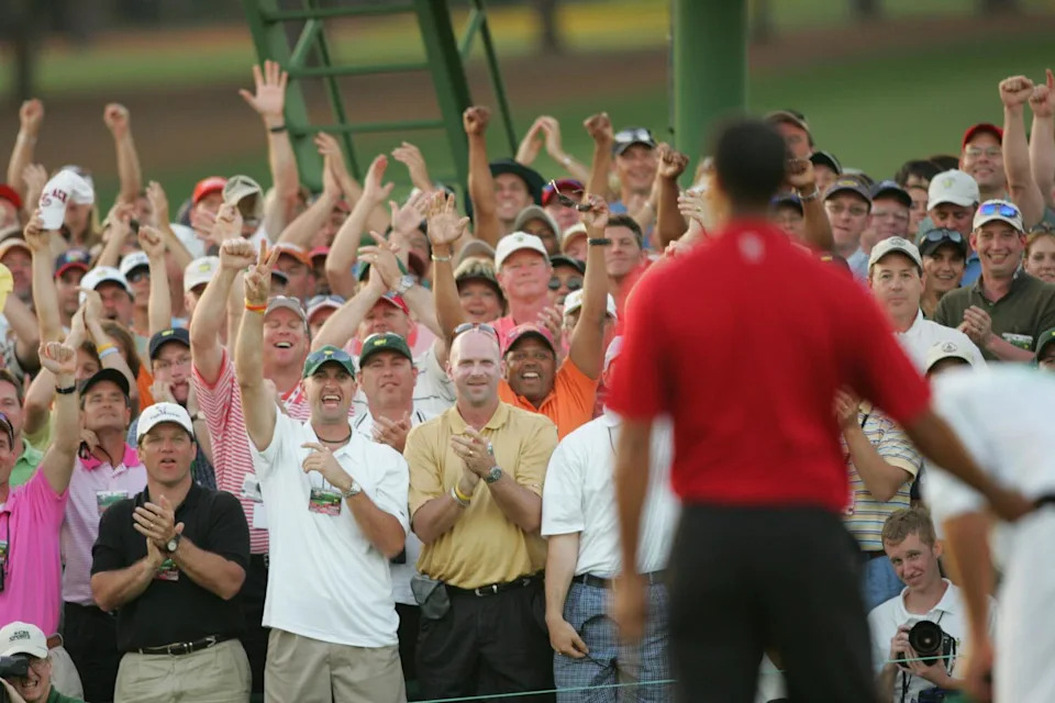 The gallery celebrates after Tiger Woods makes a birdie putt on the first hole of a playoff to win the 2005 Masters.
