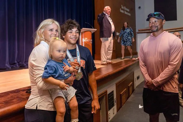Greg Lovet/The Palm Beach Post/USA Today Network Elin Nordegren poses with two of her children as ex-husband Tiger Woods looks on in March 2024