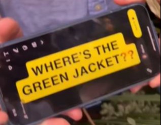 A fan held up their phone with the message 'where's the green jacket?' to McIlroy