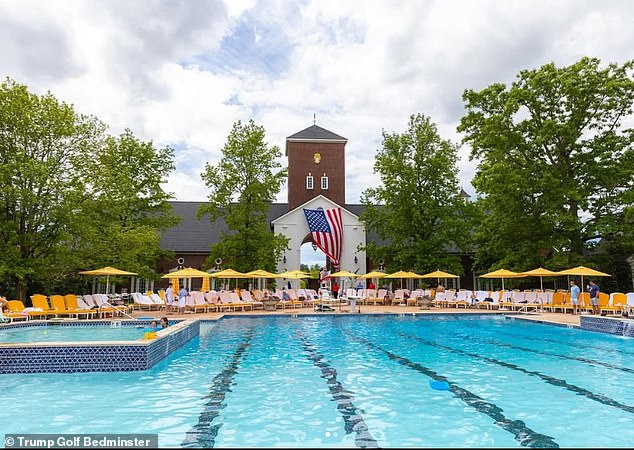 The pool at Bedminster, behind it a giant America flag flies on the barn