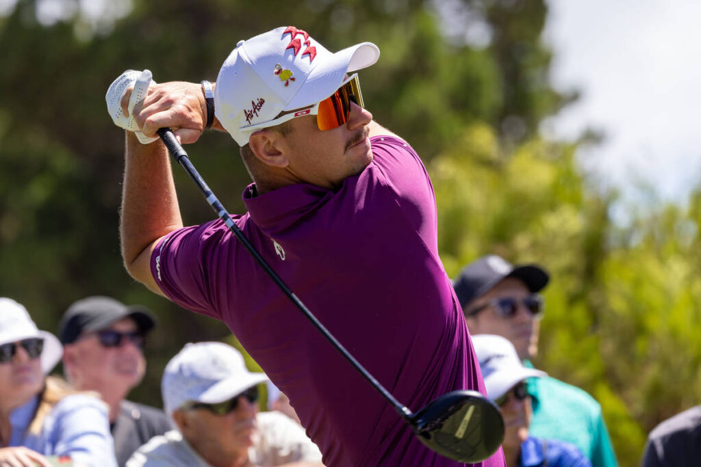 A close up shot of a male golf player after swinging his putt at LIV Golf.