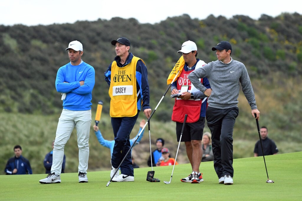 Rory McIlroy and Paul Casey wait on the green during the second round of the 2019 Open Championship
