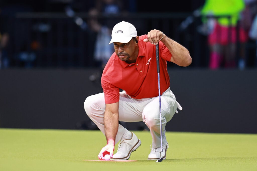 Tiger Woods lines up a putt during TGL