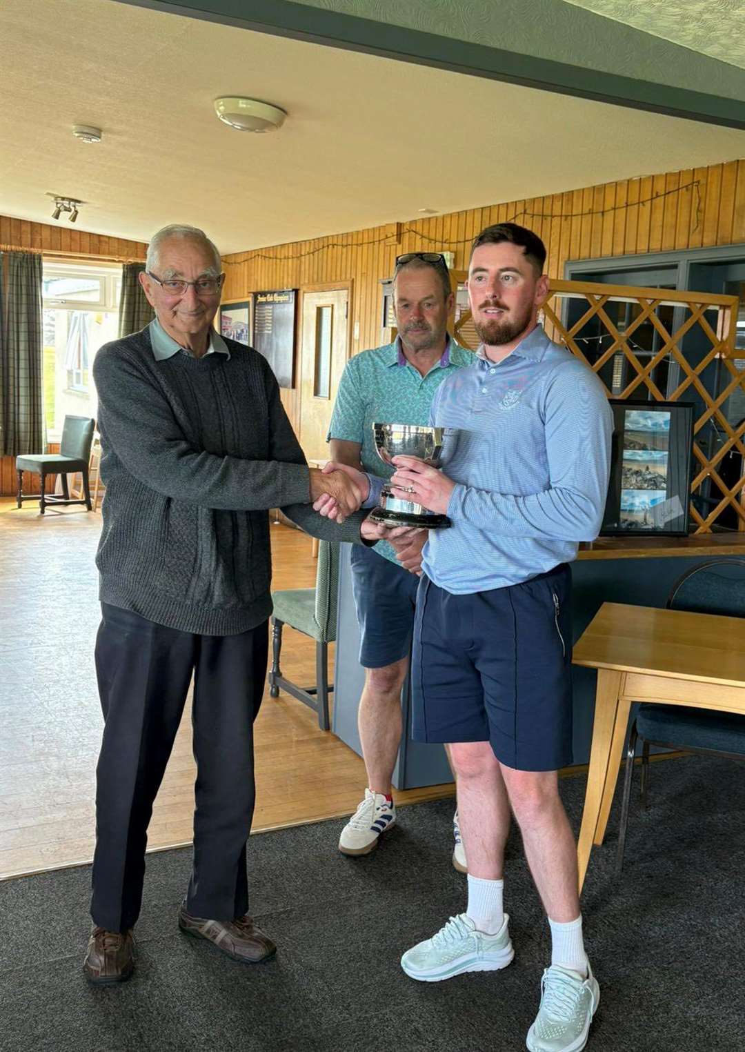 Drew MacDonald, who was presented with the trophy by honorary life member Donnie Jack.