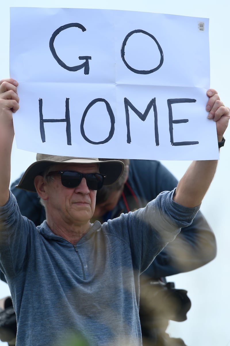 A protestor holds a placard.