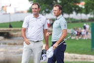 Scottie Scheffler (left) shakes hand with Jordan Spieth following the 18th hole the first...