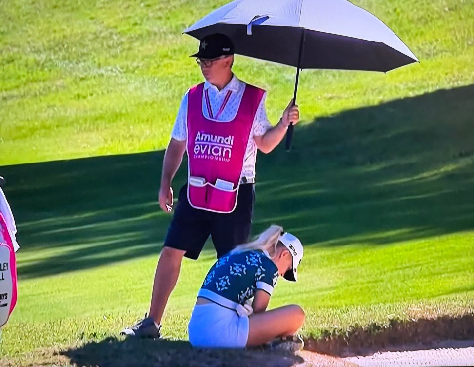 Golfer Charley Hull collapses on the course.