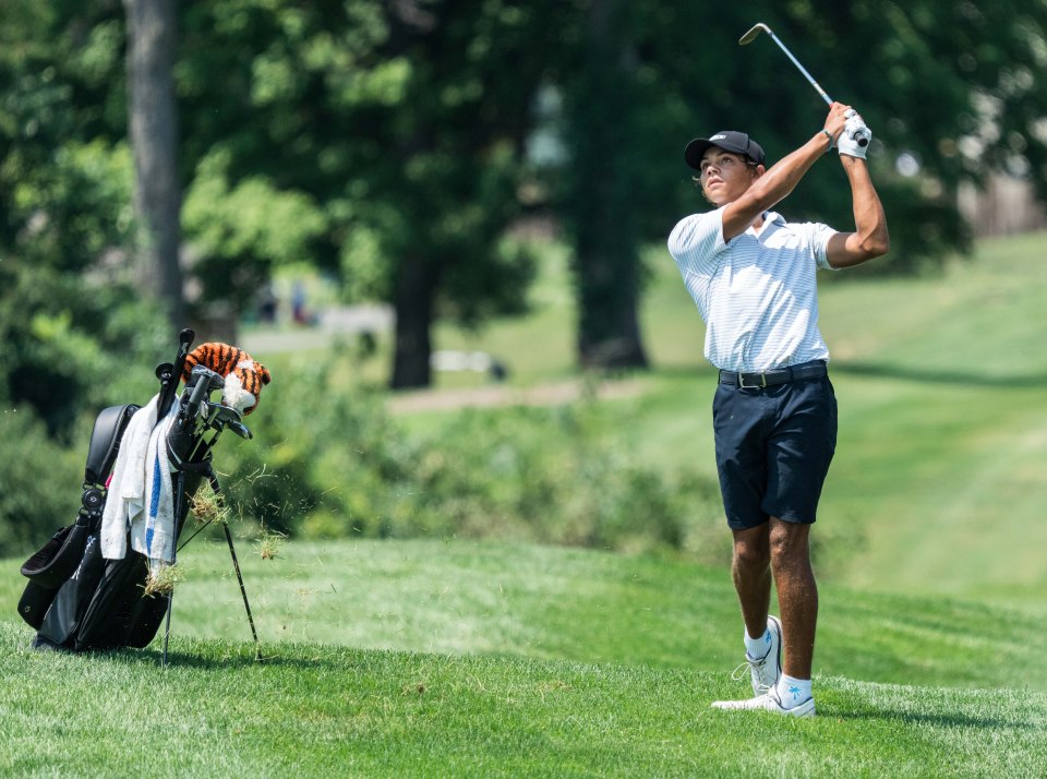 Charlie Woods hitting a golf ball from the fairway.