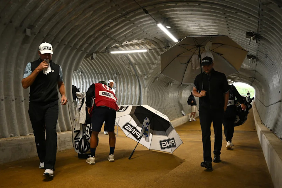PORTRUSH, NORTHERN IRELAND - JULY 18: Corey Conners of Canada and Wyndham Clark of the United States walk through a tunnel during Day Two of The 153rd Open Championship at Royal Portrush Golf Club on July 18, 2025 in Portrush, Northern Ireland. (Photo by Charlie Crowhurst/R&A/R&A via Getty Images)Charlie Crowhurst&sol;R&A&sol;Getty Images