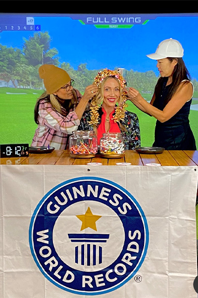 Anya getting help from friends to put golf tees in her hair