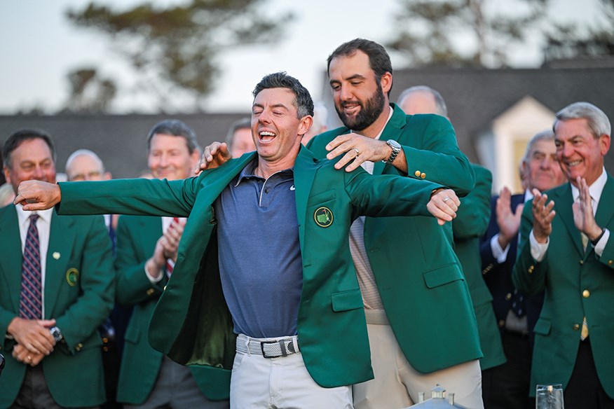 2024 champion Scottie Scheffler puts the Green Jacket on 2025 champion Rory McIlroy.