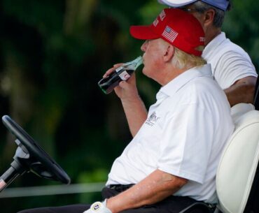 Donald Trump drinks a Diet Coke while playing golf in Florida in 2022. Pic: AP