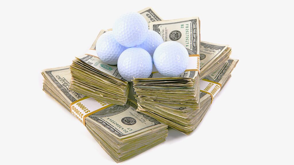 Golf balls on bundles of money