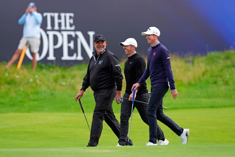 Darren Clarke, Tom McKibbin and Rory McIlroy stride towards the 18th green at Royal Portrush on Tuesday morning.